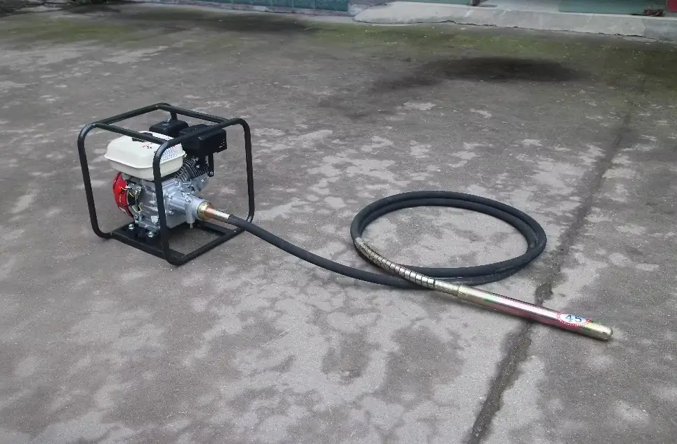 Gasoline Concrete Vibrator on the floor further away