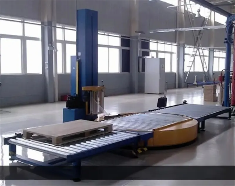 Blue pallet wrapping machine on conveyor