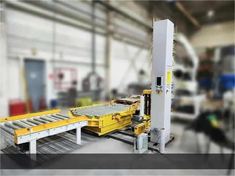 Pallet wrapping machine on conveyor belt