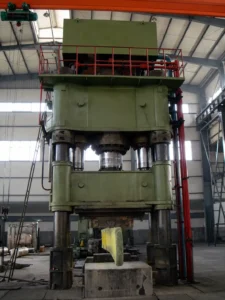 front_view_green_hydraulic_press_with_hot_workpiece